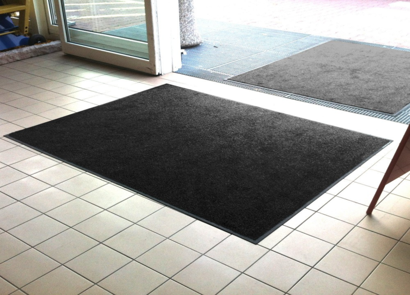 Entrance mats on each side of a door.