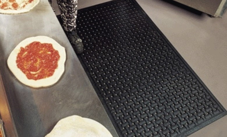 A person standing on a anti-fatigue mat.