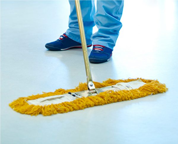 Treated dry mop being used on floor