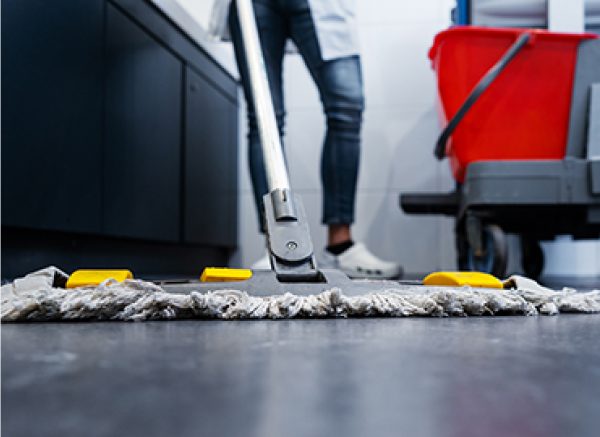 Treated dry mop being used on floor close up