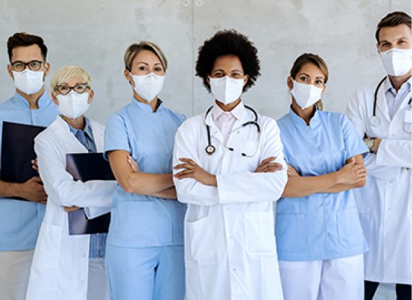 Six people wearing lab, dental and counter coats