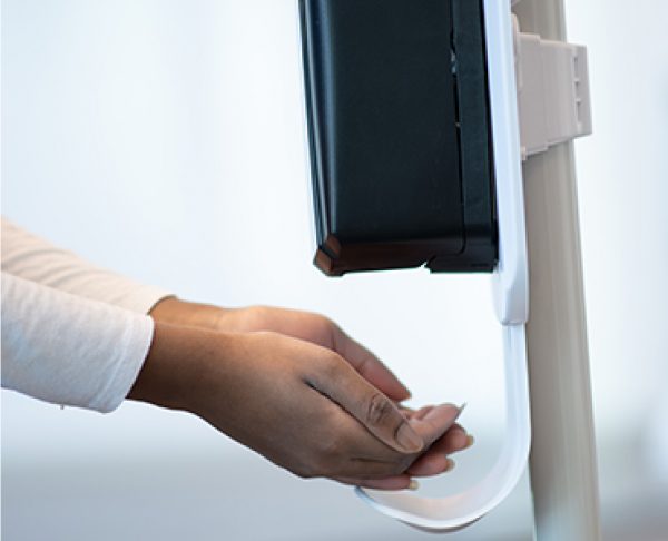 Hand sanitizer dispenser being used