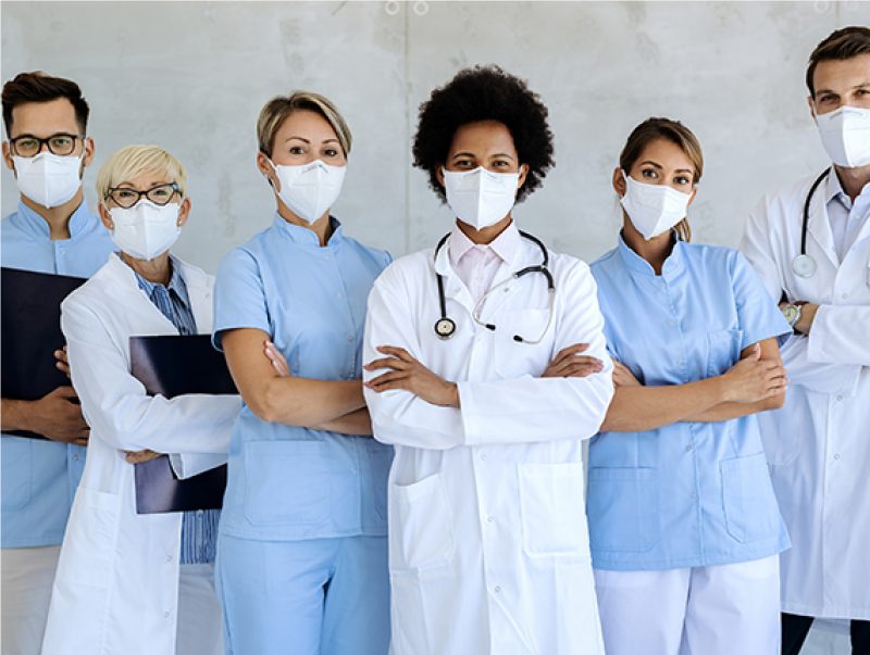 Six people wearing lab, dental and counter coats