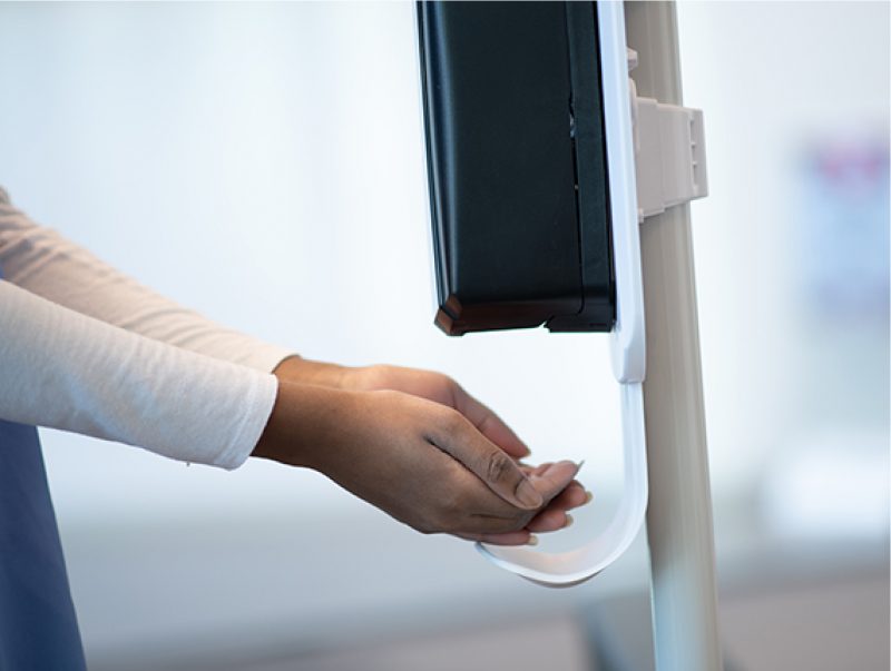 Hand sanitizer dispenser being used